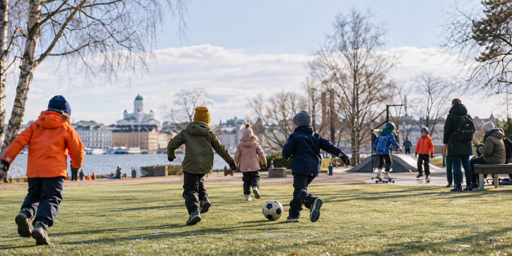 Children playing casually outdoors in a Helsinki park setting
